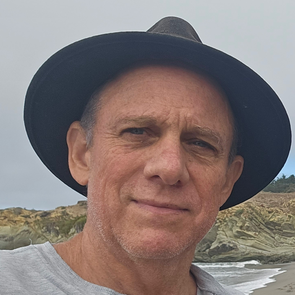 man with hat gazes at camera