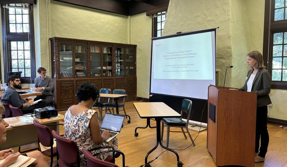 Scholars attend a presentation in a classroom.