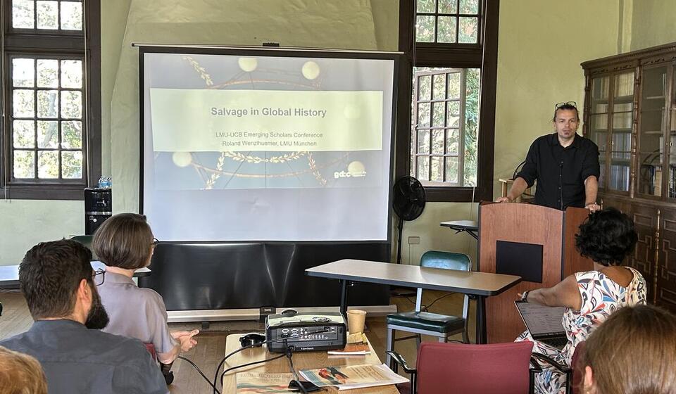 Scholars attend a presentation in a classroom.