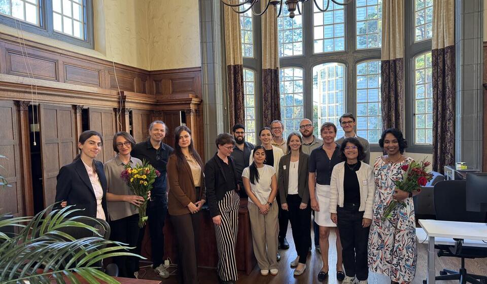 A group of people stand together for a group photograph.