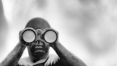 Image of a person holding binoculars